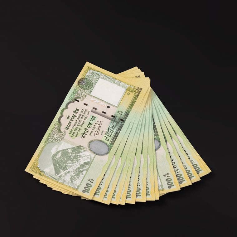 A bundle of banknotes of Rupees 100 in a spread - Photos Nepal