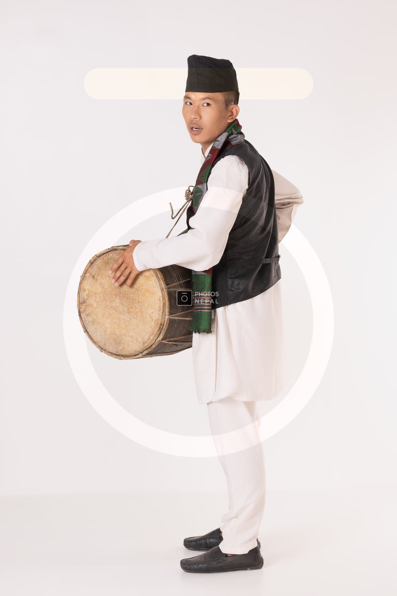 Traditional Rai Instrument A handsome Rai boy holding Dhol while wearing traditional dress ...