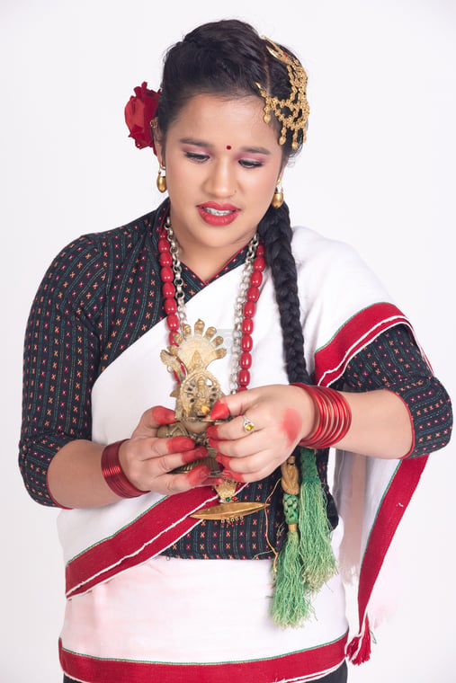 A religious Newari woman holding Sukunda oil Lamp - Photos Nepal