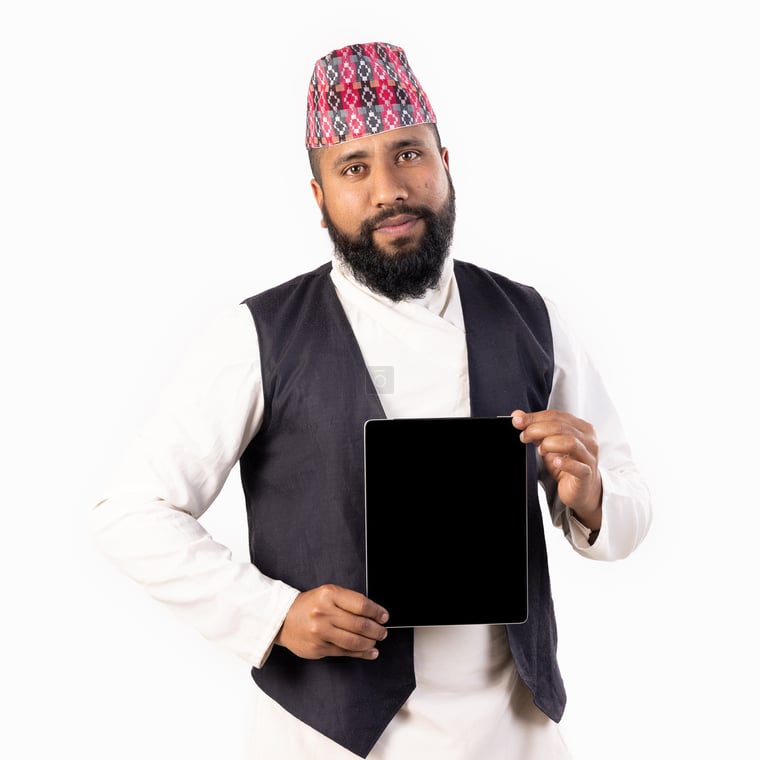 Traditional Nepali Man Displays iPad Screen with Confidence in Daura Suruwal and Dhaka Topi